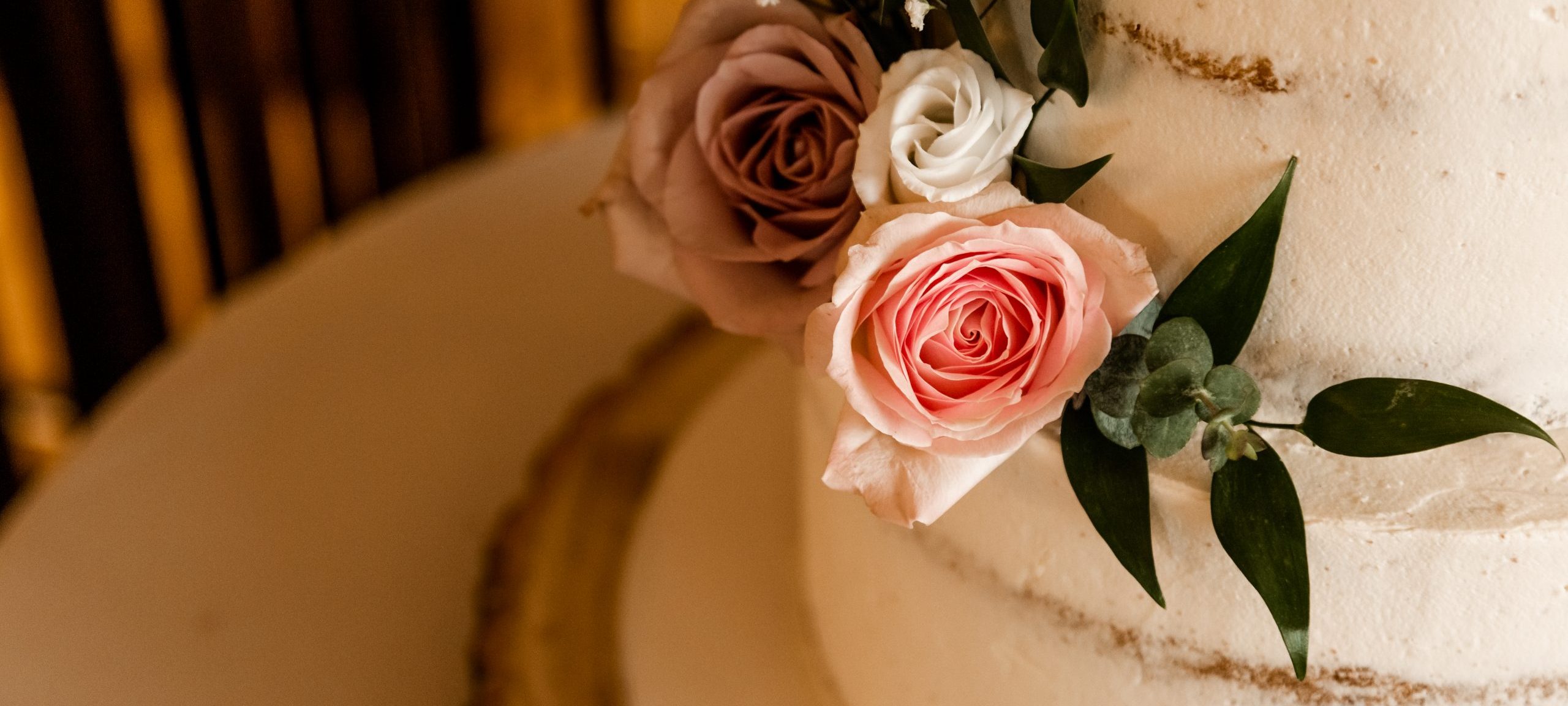 Close up of roses on a wedding cake