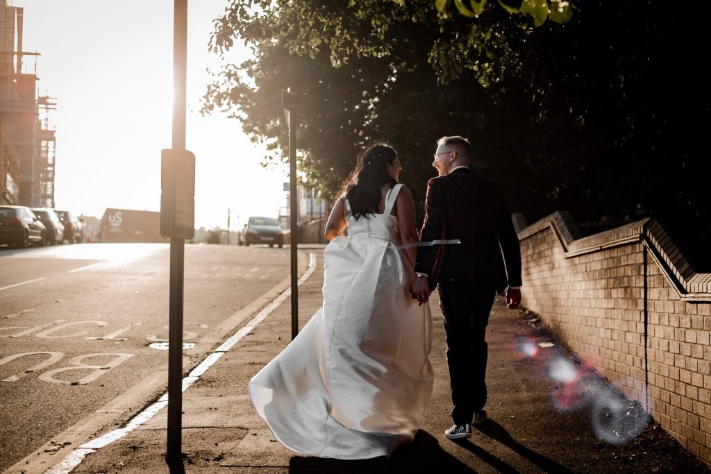 Isabelle Biggs Photography - Bride & Groom walking away in the sunset