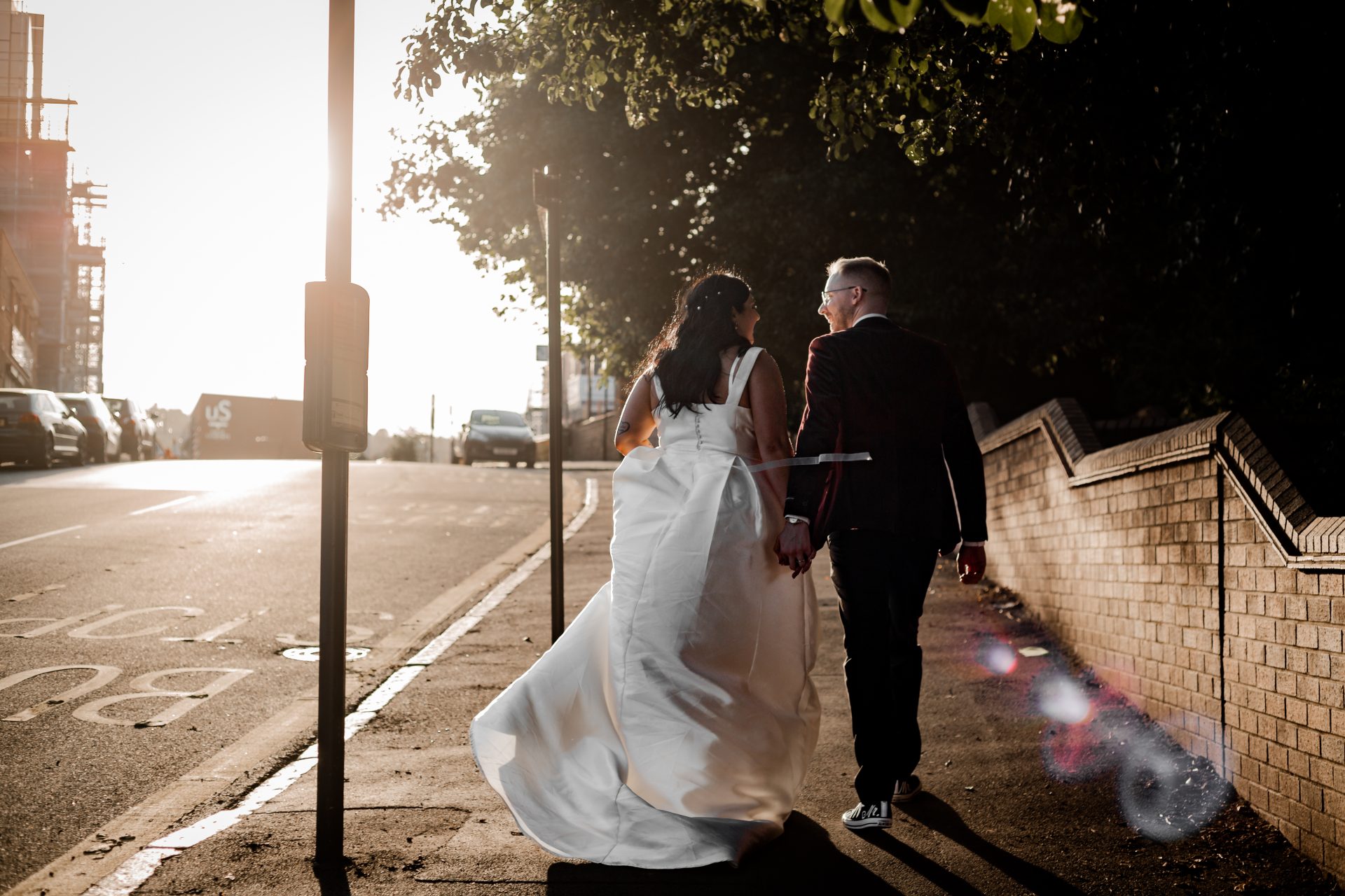 Isabelle Biggs Photography - Alternative Bride & Groom walking away in the sunset