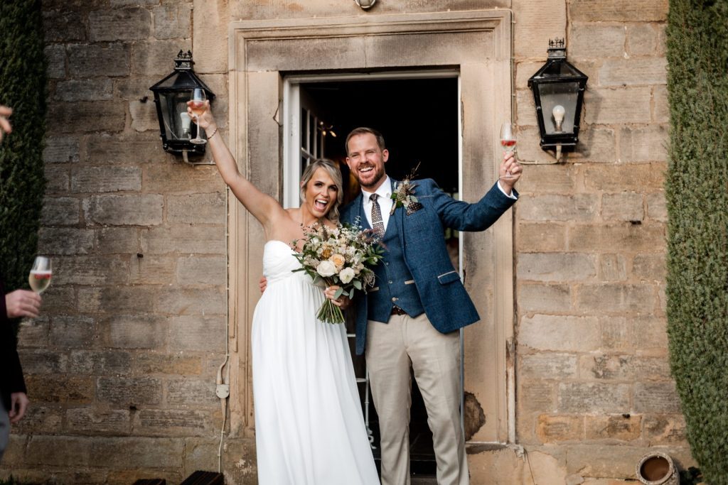 Bride & Groom pose outside of their venue after the wedding ceremony at their micro wedding at The Cavendish Hotel