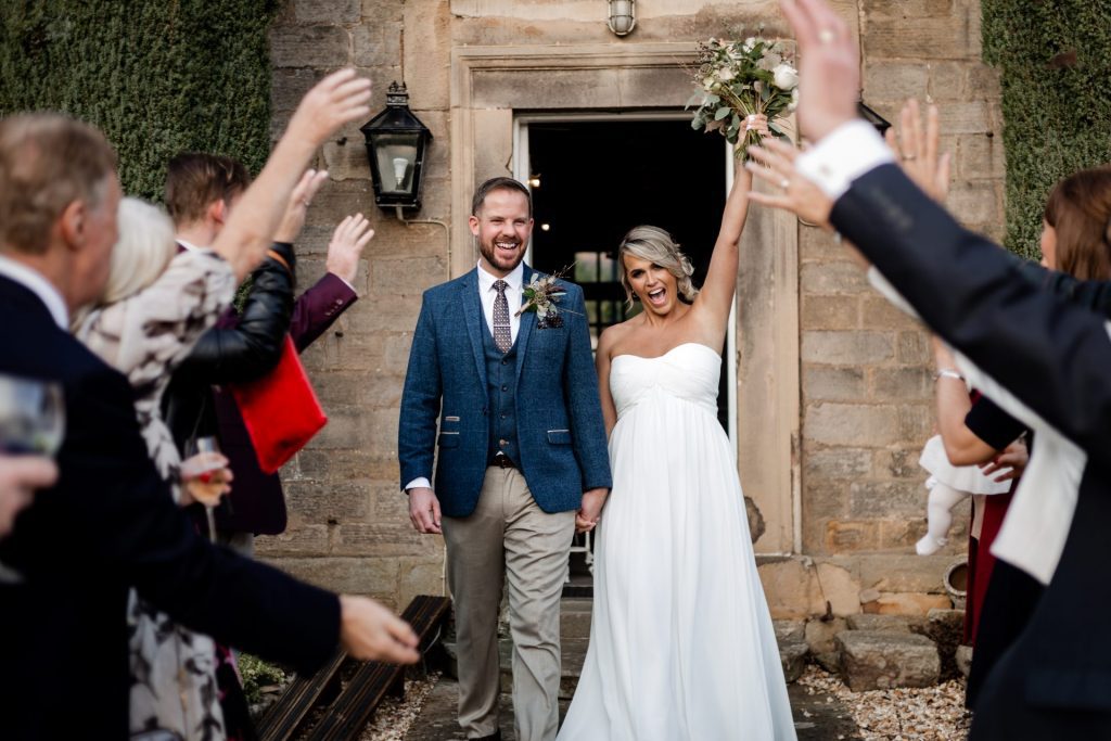 Bride & Groom walk through the tunnel of wedding guests at their micro wedding at The Cavendish Hotel