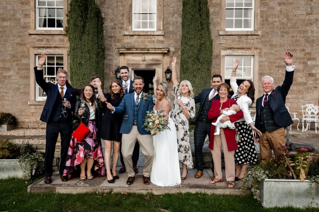 Bride, Groom and wedding party pose together for group photo at their micro wedding at The Cavendish Hotel