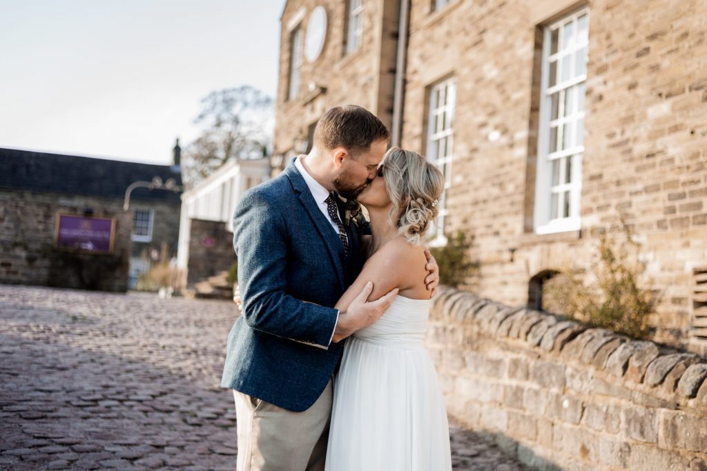 Bride & Groom kiss outside of their venue after the wedding ceremony at their micro wedding at The Cavendish Hotel