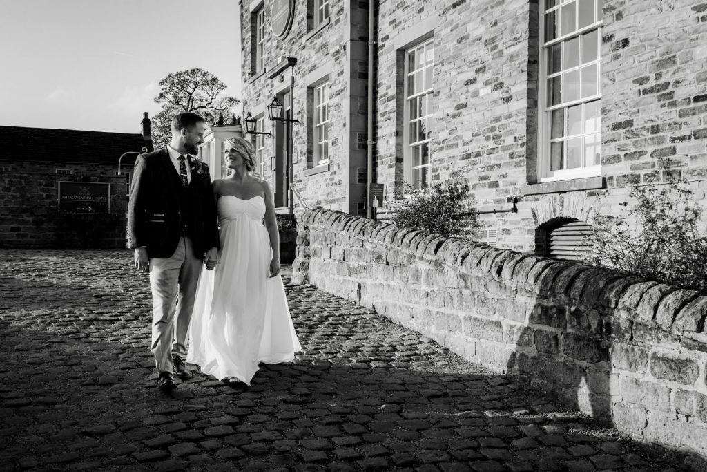 Bride & Groom take a stroll outside of their venue after the wedding ceremony at their micro wedding at The Cavendish Hotel