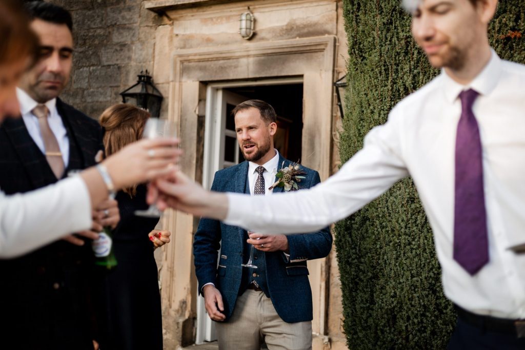 Candid photo of Groom and wedding guests at a micro wedding at The Cavendish Hotel