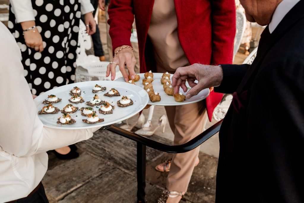 Detail photo of wedding guests tucking into canapes at a micro wedding at The Cavendish Hotel