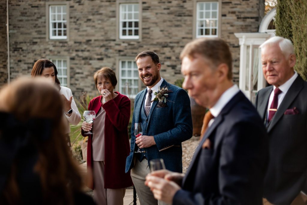 Candid photo of Groom and wedding guests at a micro wedding at The Cavendish Hotel