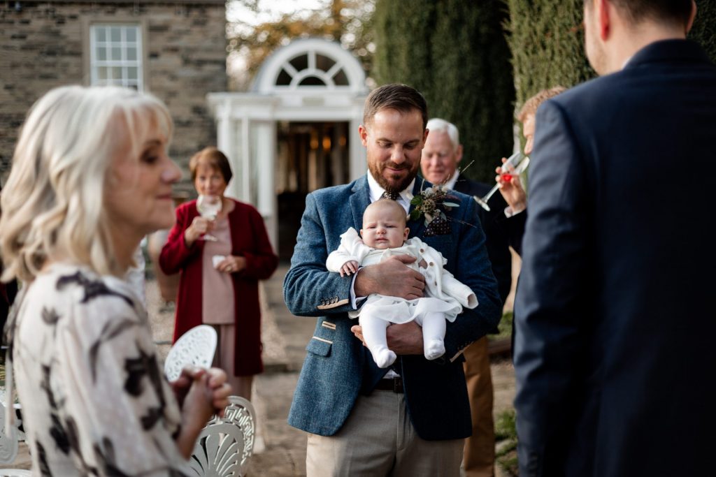 Candid photo of Groom and wedding guests at a micro wedding at The Cavendish Hotel