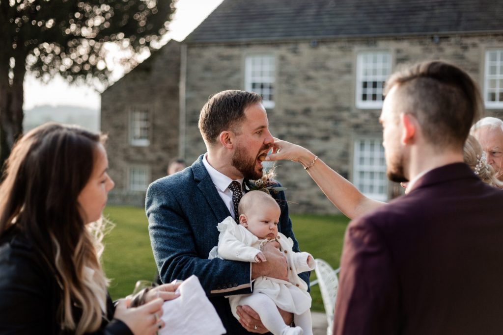 Candid photo of Groom and wedding guests at a micro wedding at The Cavendish Hotel