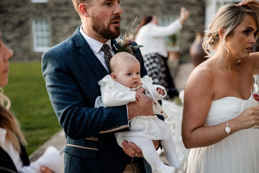 Candid photo of Groom and wedding guests at a micro wedding at The Cavendish Hotel