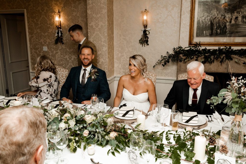 Bride, groom & guests sitting down at the wedding breakfast of their Micro wedding at The Cavendish Hotel