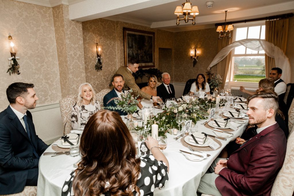 Bride, groom & guests sitting down at the wedding breakfast of their Micro wedding at The Cavendish Hotel