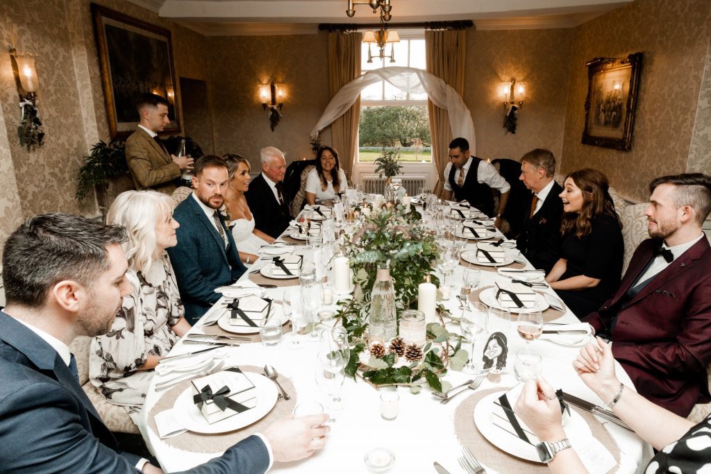 Bride, groom & guests sitting down at the wedding breakfast of their Micro wedding at The Cavendish Hotel