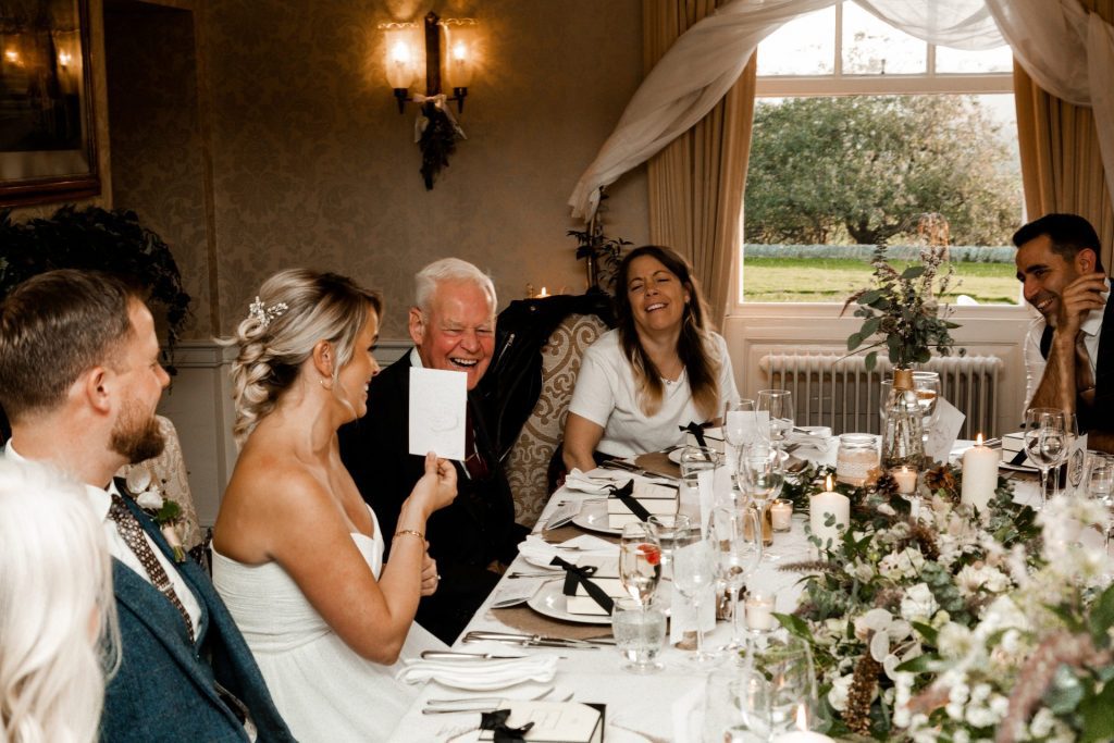 Wedding guests reacting to wedding favours at Katie & Paul's Micro wedding at The Cavendish Hotel