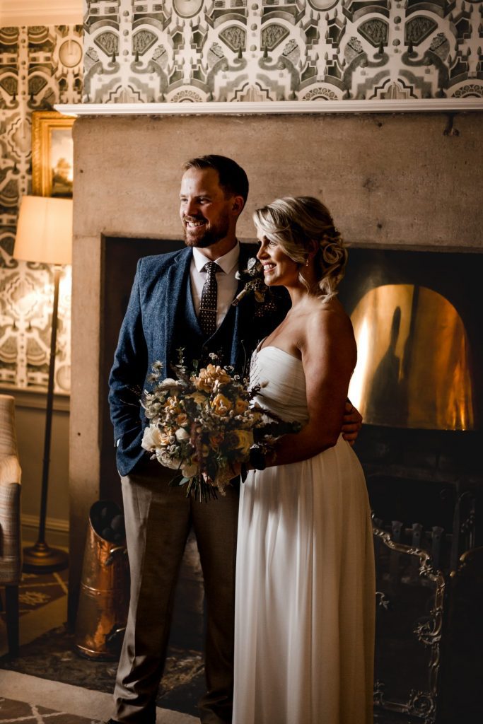 Candid photo of the Bride & Groom with their wedding flowers at their micro wedding at The Cavendish Hotel