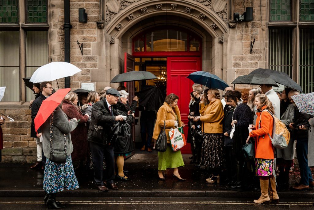 Wedding party gathering outside the Bakewell Town Hall ready for the confetti. Photo in colour