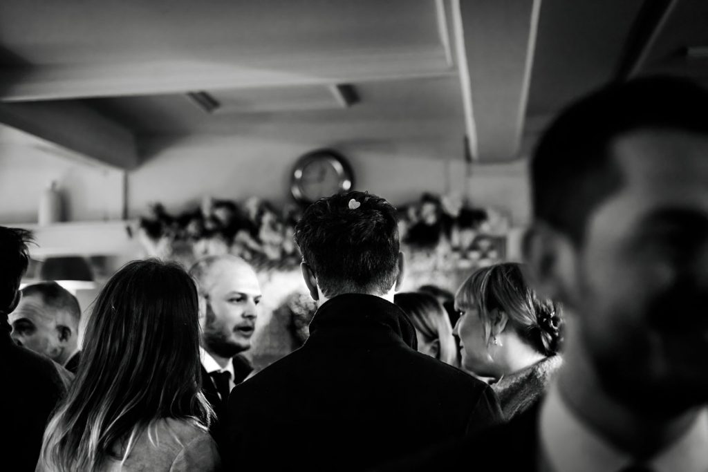 Candid photo of wedding party after the wedding ceremony. Photo in black & white
