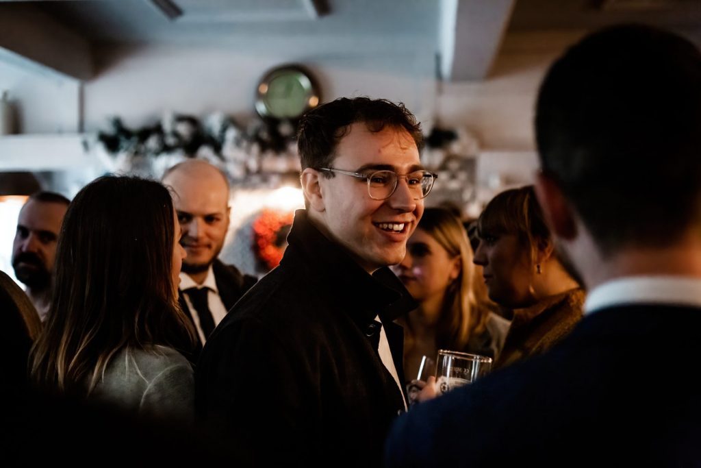 Candid photo of wedding party after the wedding ceremony. Photo in colour