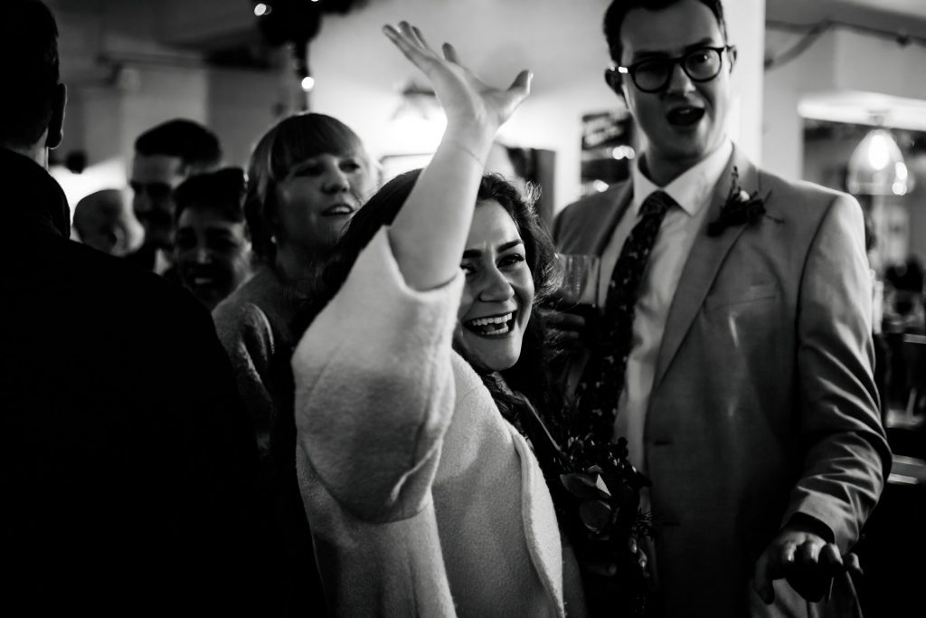 Candid photo of wedding party after the wedding ceremony. Photo in black & white