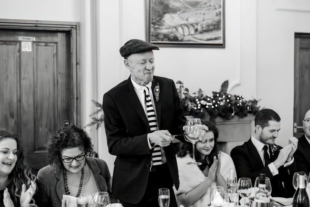 Candid photo during the wedding speeches at the Monsall Head Pub. Photo in black & white.