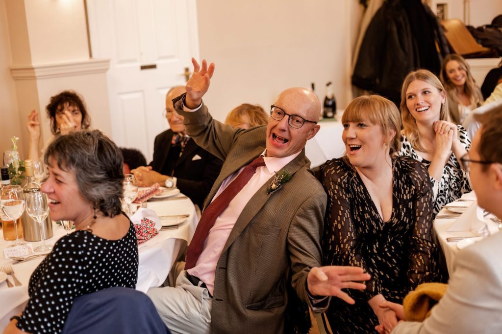 Candid photo during the wedding speeches at the Monsall Head Pub. Photo in colour.