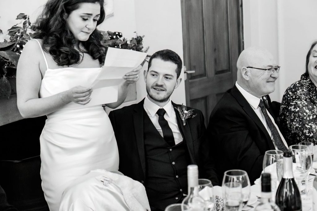 Candid photo during the wedding speeches at the Monsall Head Pub. Photo in black & white.