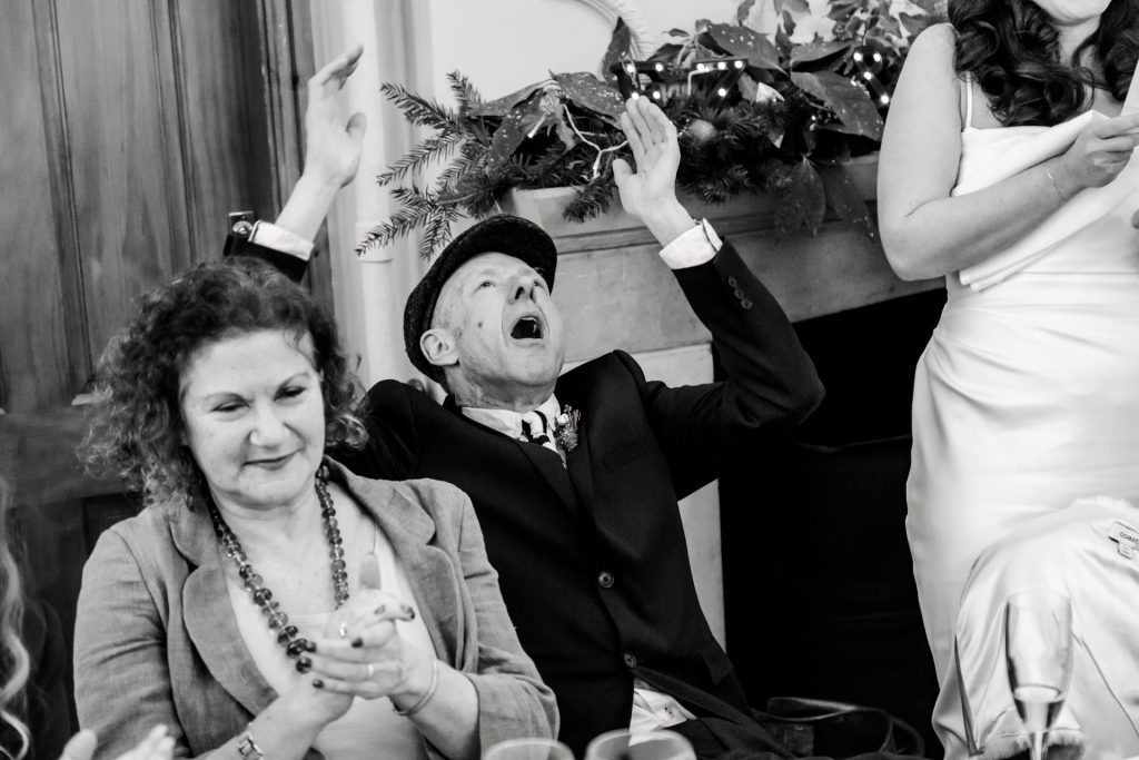 Candid photo during the wedding speeches at the Monsall Head Pub. Photo in black & white.