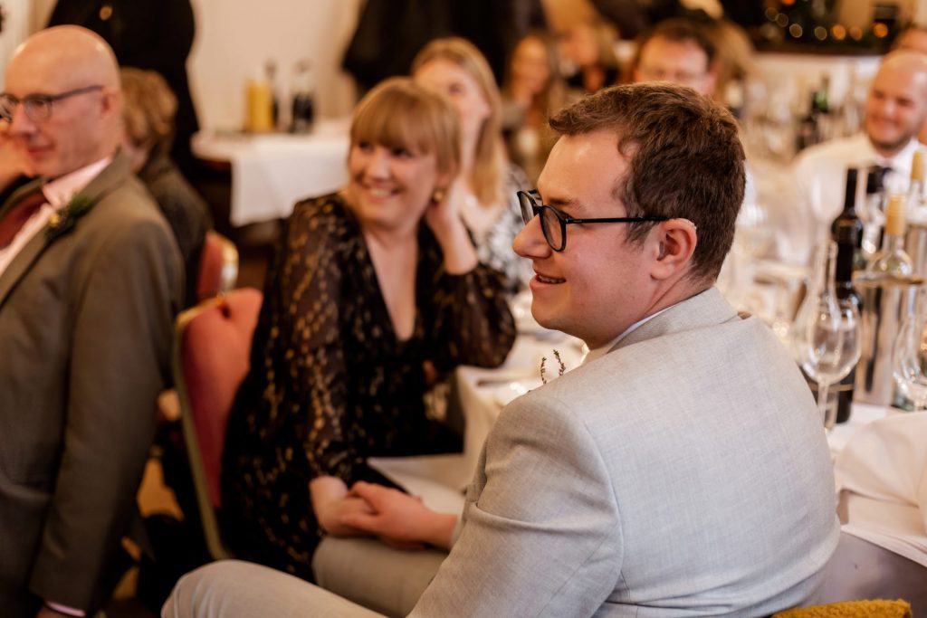 Candid photo during the wedding speeches at the Monsall Head Pub. Photo in colour.