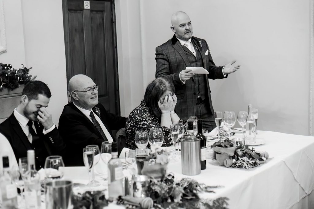 Candid photo during the wedding speeches at the Monsall Head Pub. Photo in black & white.