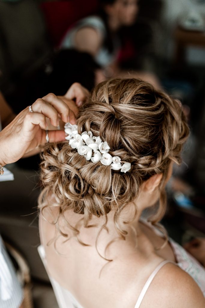 Bride having her delicate hairpiece added to her bridal hair during the bridal prep