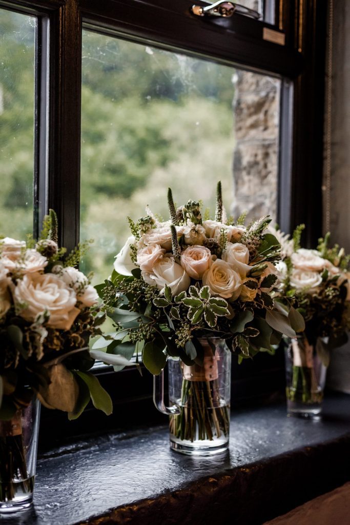 The bridal bouquet and wedding flowers set on the window sill at The Venue, Halifax