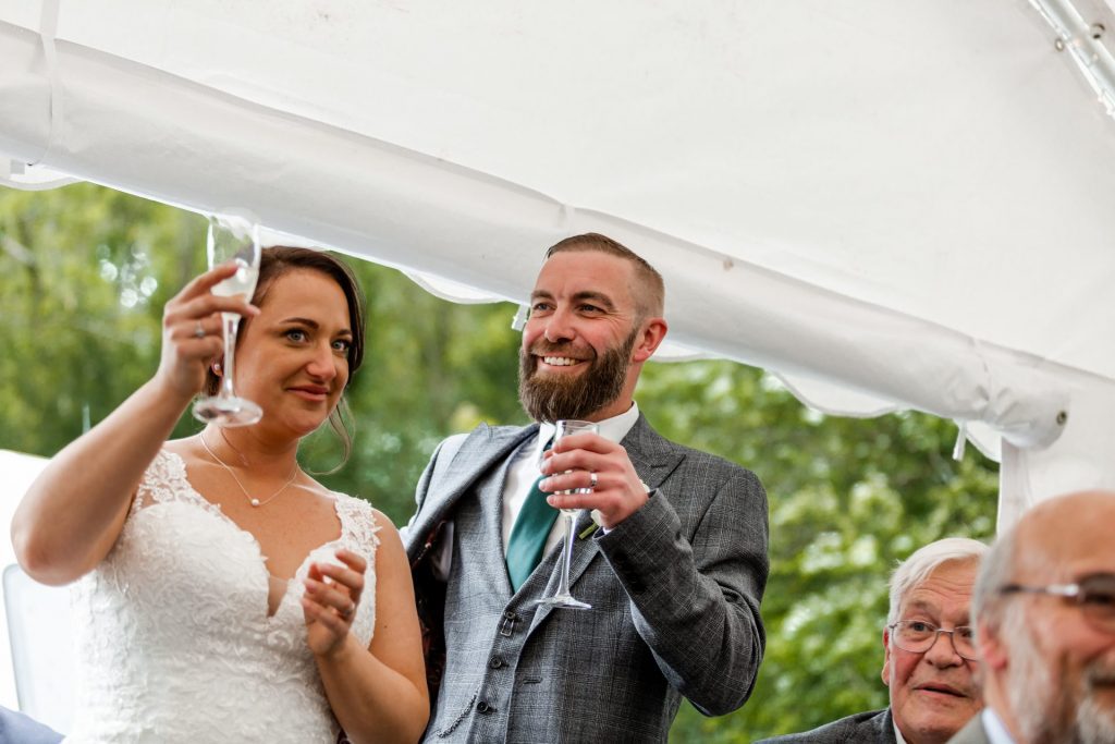 A close up of the groom during their speeches
