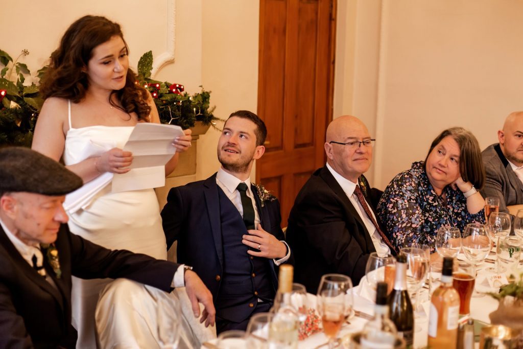 The groom looking up at his new wife during her speech