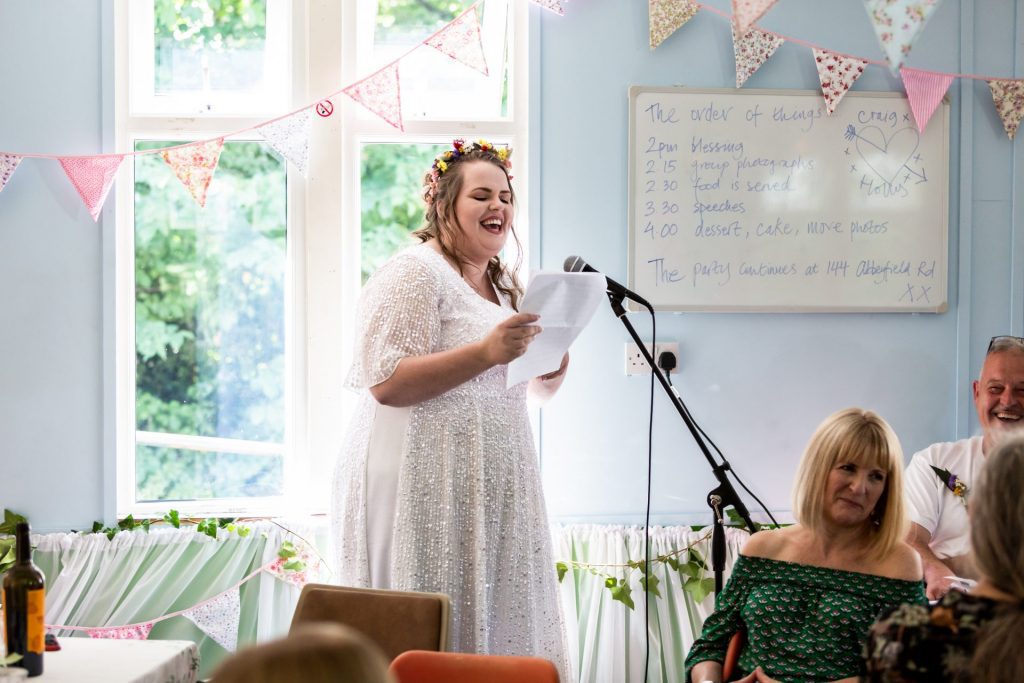 The bride smiling during her speech at the reception
