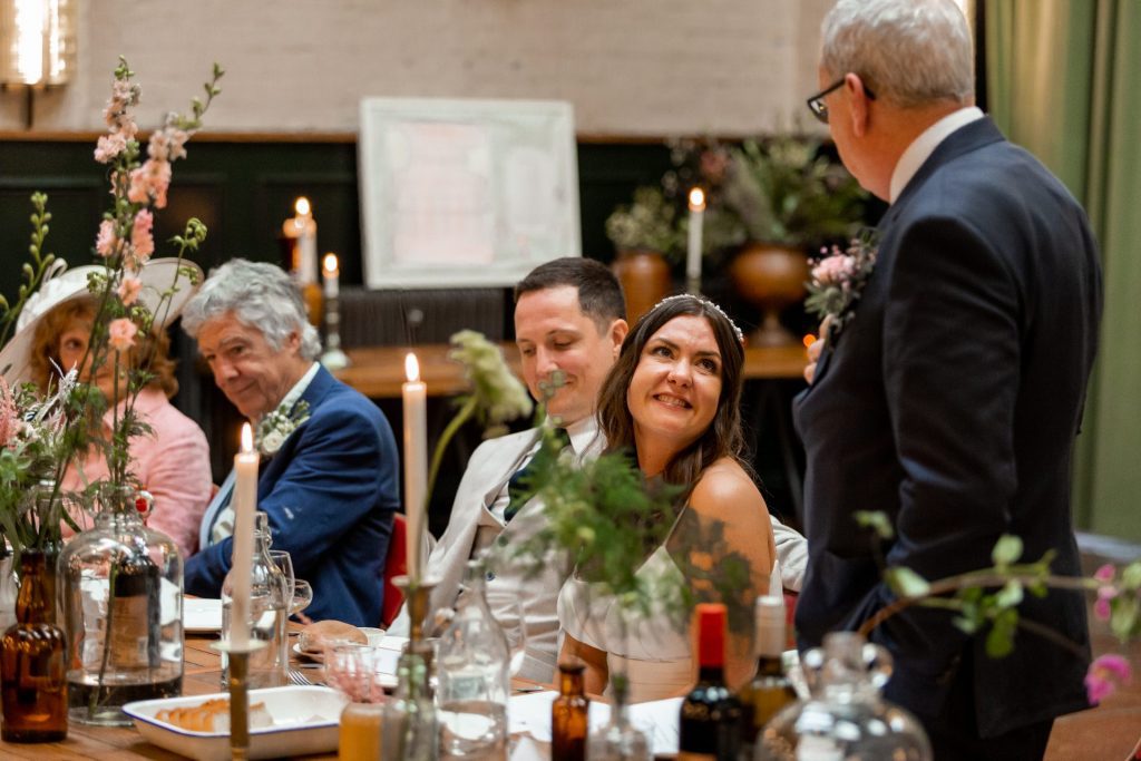 Bride looking up at her father whilst delivering his speech