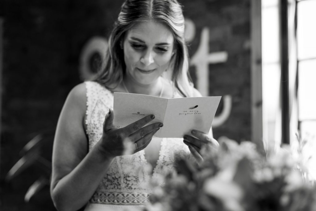 Shot of the bride reading her personal vows before her wedding ceremony at The Chimney House wedding venue, Kelham Island, Sheffield. Isabelle B Photography