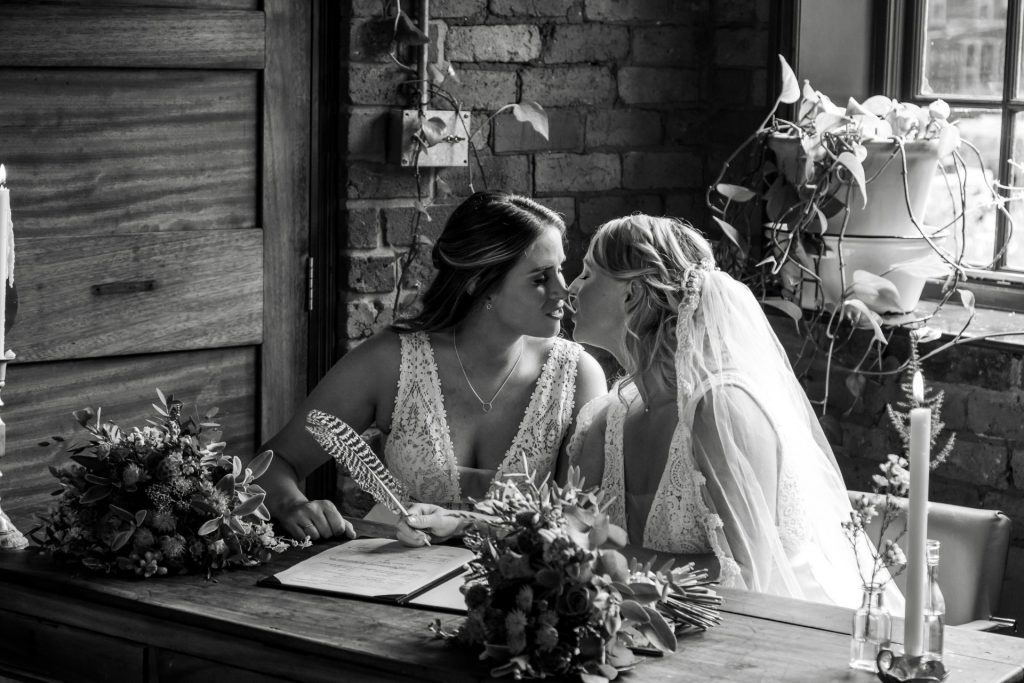 Zoomed in shot of the new Mrs & Mrs Kissing after signing their marriage certificate at The Chimney House wedding venue, Kelham Island, Sheffield. Isabelle B Photography