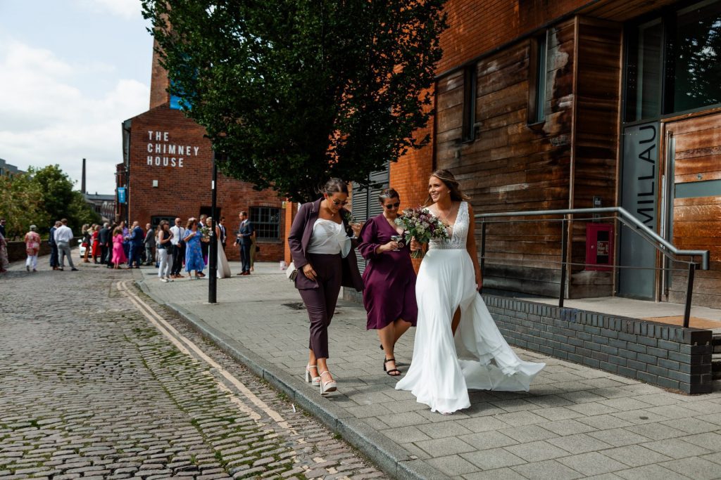 Wide shot of the Bride and her girls walking away from The Chimney House wedding venue, Kelham Island, Sheffield. Isabelle B Photography