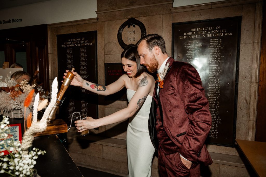 Bride & Groom pictured pulling a pint instead of cutting a wedding cake or first dance. Alternative to the first dance