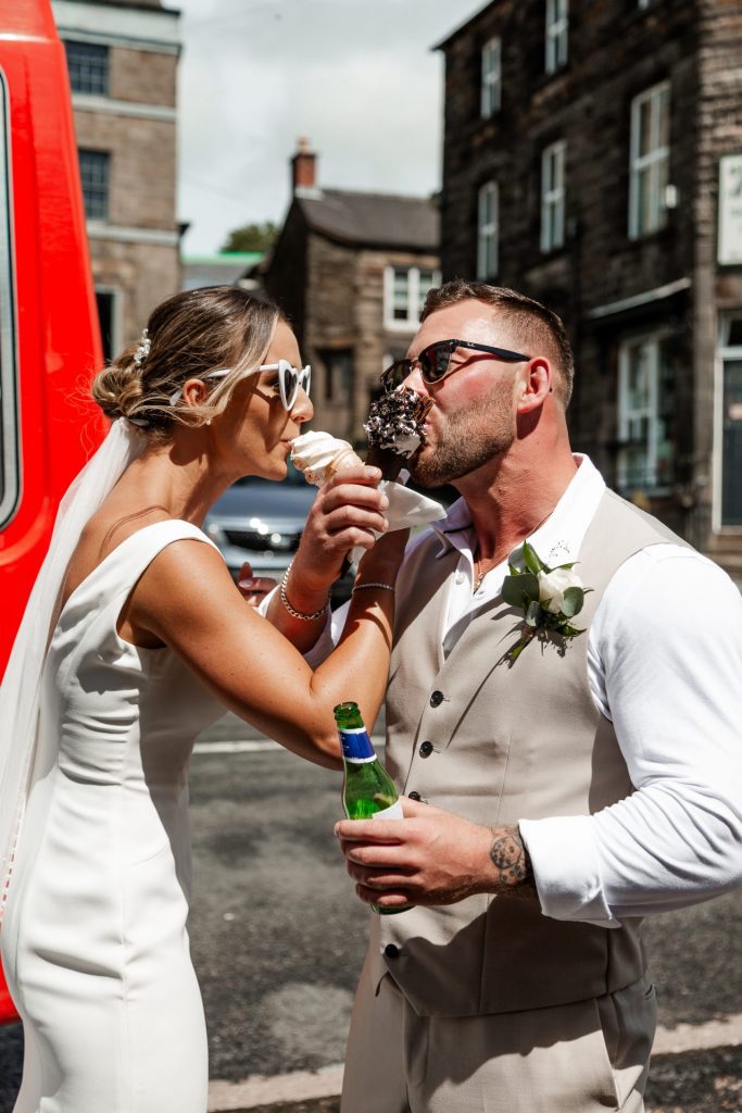 Bride and groom taking a lick of their ice creams whilst linking arms