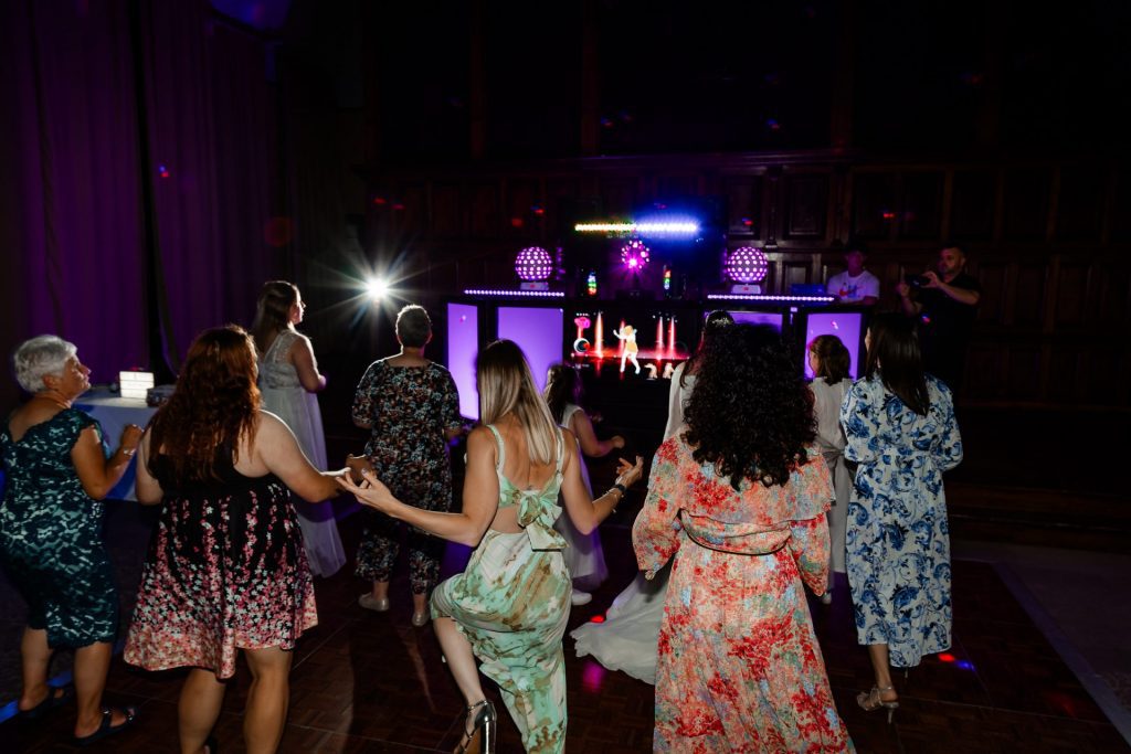 Guests dancing along together at a wedding reception