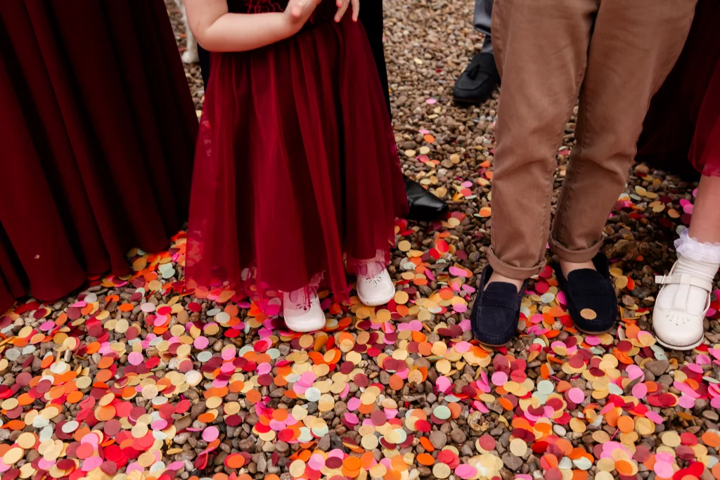 Cropped in shot showing all the paper confetti on the ground after the confetti shot - Isabelle B Photography