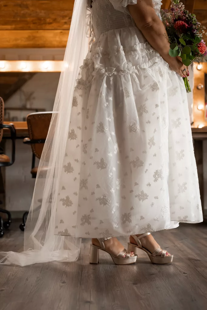 A close up of the bride in her alternative wedding dress at the Grange Barn, Cheshire