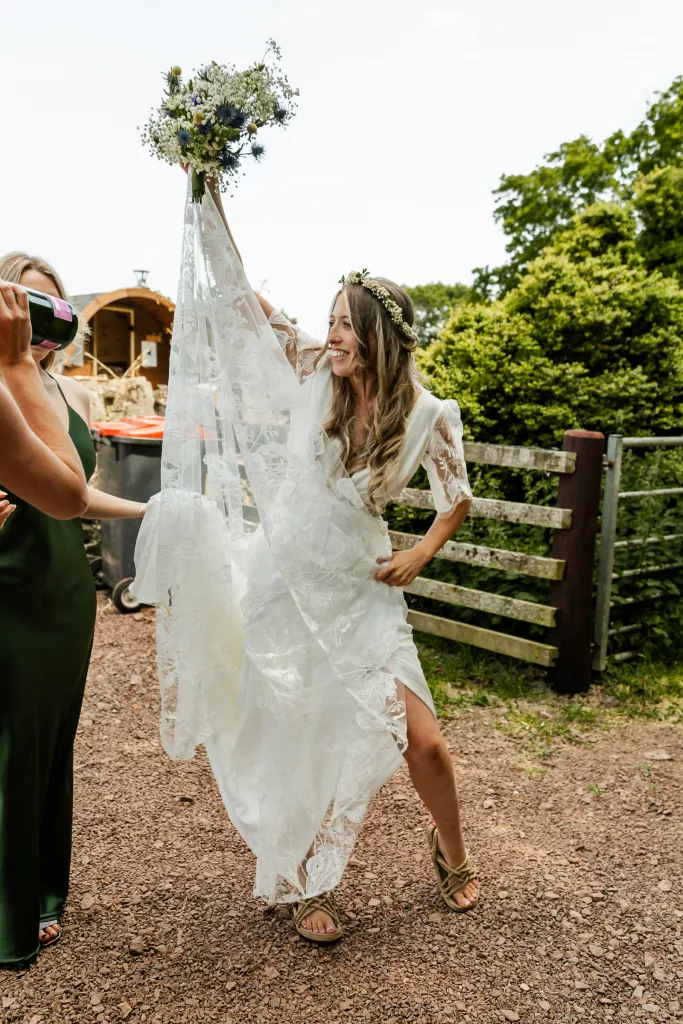 The Bride smiling before her wedding ceremony at Harvest Moon wedding venue in Scotland. The bride is wearing a rembo styles wedding dress and flower crown
